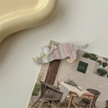 Detailed view of cat-shaped hair clip with iridescent pearlescent finish and gold outlines - Gray