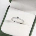 Detailed view of silver T-shaped letter ring with small diamonds in green jewelry box - Platinum T