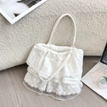 Details von geschichteter weißer Spitze und Stickerei auf einer Damen-Stofftasche - Weiß