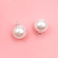 Spherical faux pearl pendant with silver metal loop on a clean pink background - 10mm Silver Round