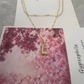 Golden letter L pendant necklace with textured finish and layered chain for women - L