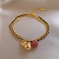 Detail of 18k gold-plated cat eye stone bracelet with gourd charm and lobster clasp closure - Gold - Black Woven Hulu Pendant