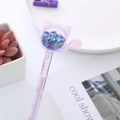 Cat-shaped gel pen with purple glitter and cherry blossom patterns in a lifestyle setting - Purple Cat