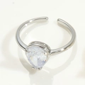 Detail of silver adjustable ring featuring a large pear-shaped sparkling crystal stone - Adjustable Open / Silver Teardrop
