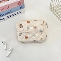Macro detail of quilted cream storage pouch featuring cartoon bears and button pocket - Goodnight Bear