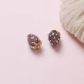 Detailed view of dusty purple strawberry pendant with white dots and gold leaf cap - Gray