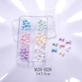 Close-up of glittery resin bow nail art charms in a 6-grid transparent organizer box - Colorful Bow Style (H28)
