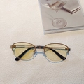 Detailed view of vintage oval gold metal frames with light yellow tinted lenses - Gold Frame Yellow Lenses