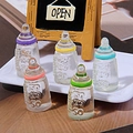 Five colorful miniature resin baby bottles with detailed scale markings for DIY crafts - Multicolor