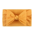 Detail of soft bright yellow nylon headband with a large elastic bow for infants - Earthy Yellow