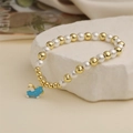 Bracelet charmant en perles et or avec un pendentif poney en émail bleu sur pierre - Pégase Bleu