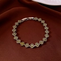 Detail of silver clover chain bracelet with green zircon on brown velvet fabric - Silver-Yellow Green (Clover)