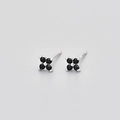 Macro shot of S925 sterling silver stamp on four-leaf flower stud earring with black stone - Rhodium Base Black Zirconia