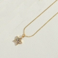 Golden necklace featuring a star-shaped pendant with colorful zircon stones on woven fabric - Colorful Zirconia Star Style