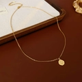 Close-up of golden starburst medallion pendant with tiny crystal on a dainty chain - Gold (Real Gold Plated)