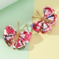 Handmade floral fabric butterfly hair clips with gold wire antennae on a soft background - Red Floral Butterfly (2Pcs)