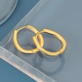 Detailed close-up of oval gold earrings with S925 silver hallmarks on acrylic stand - Oval Hoop Earring / Gold