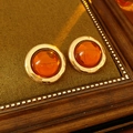 Detail of vintage round amber resin earrings with golden metal frames in a wood tray - Silver Needle Earrings-Gold-Brown