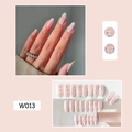 Detailed view of pink French press-on nails with white flower patterns on model's hands - W013 White Flowers