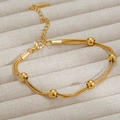 Three-strand golden stainless steel snake chain bracelet with polished bead accents - Triple Layer Bead (E2082) Gold