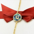 Golden bracelet with round abalone shell pendant featuring letter Q on red ribbon - Letter Q