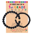 Two black beaded bracelets with gold heart charms on a First Day of School card - Black
