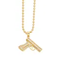 Detailed macro view of gold-plated machine gun pendant with shiny paved crystals - Handgun