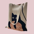 Detail of knitted tote bag featuring a cute black cat and orange yarn ball design - Ball Cat Apricot