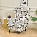 Elastic wingback chair cover with brown and grey geometric patterns in a cozy room - Plaid