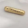 Elegant gold spring hair clip with embossed circular patterns and glossy metal finish - Gold Cylindrical Texture Clip