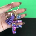Resin letter F keychain with purple tassel and glitter glass ball in golden finish - Letter F