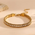 Close-up of 18k gold-plated titanium steel bracelet with sparkling clear zircon stones - Gold White Zirconia (K211)