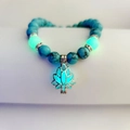 Turquoise bead bracelet featuring a glowing lotus flower charm and luminous beads - Blue Turquoise Green Glow