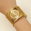 18K gold plated wide sun face cuff bracelet with wavy edges on female wrist - Apollo Relief Gold (7095)