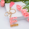 Pink resin letter E keychain with gold flakes, pink tassel and metallic hardware - Letter E