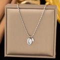 Minimalist titanium steel rice pearl necklace with silver oval pendant on jewelry box - Pearl Oval / Steel