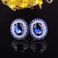 Elegant oval sapphire stud earrings with double halo zirconia setting on a black mirror base - Halo Style / Dark Blue