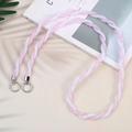Pink and white braided crossbody phone strap with silver metallic rings on a magazine - Pink & White