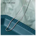 Macro shot showing detail of a polished silver box chain necklace with square links - 50 cm / Box Chain (Silver Tone)