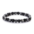 8mm black hematite beaded bracelet featuring dark metallic cylinder accents on white background - Polished Stone with Bone Shaped Spacer