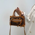 Brown leather leopard print crossbody bag with dual handles and tassel details - Tan