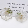 Close-up of resin flower charms with embedded dried daisies for DIY jewelry crafts - 1 Piece / White
