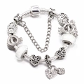 Macro detail of silver snake chain bracelet with heart charms and white beads - Tree of Life Theme (L06)
