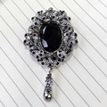 Vintage style brooch with a black oval gemstone and silver filigree crystal details - Antique Silver Black Gem Pendant