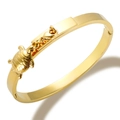 Golden hinged bangle bracelet with a detailed sea turtle charm pendant and polished finish - Turtle Bangle / Gold