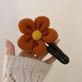 Elegant wool felt hair claw clip featuring large orange flower and green fabric base - Orange