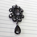 Retro black flower brooch with rhinestones and a grey crystal teardrop pendant - Gun Black Grey Gem Pendant
