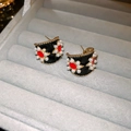 Detailed view of vintage C-shape earrings with black enamel and red pearl floral patterns - 6# Red & Black Polka Dot C-Shape Pearl Stud Earrings