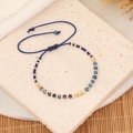 Detail of blue crystal beaded bracelet with adjustable woven cord on textured stone - 5# Royal Blue / Royal Blue