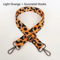 Detail of light orange leopard print wide nylon bag strap with gunmetal swivel hooks - Light Orange + Gunmetal Hook